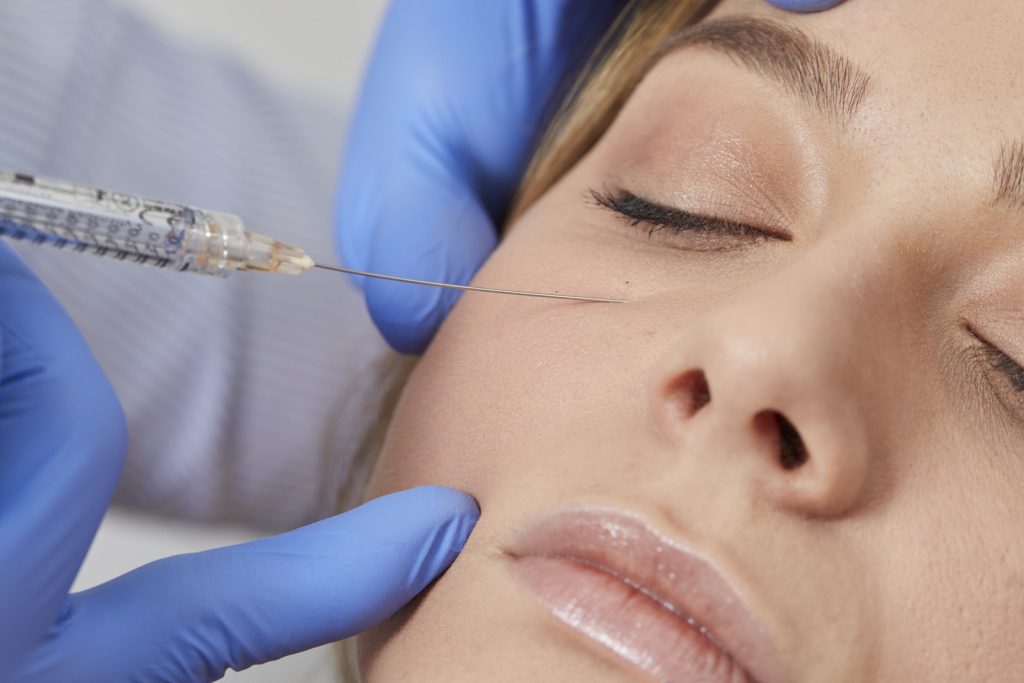 Dr Joshua Van der Aa administers a treat trough filler treatment, close-up